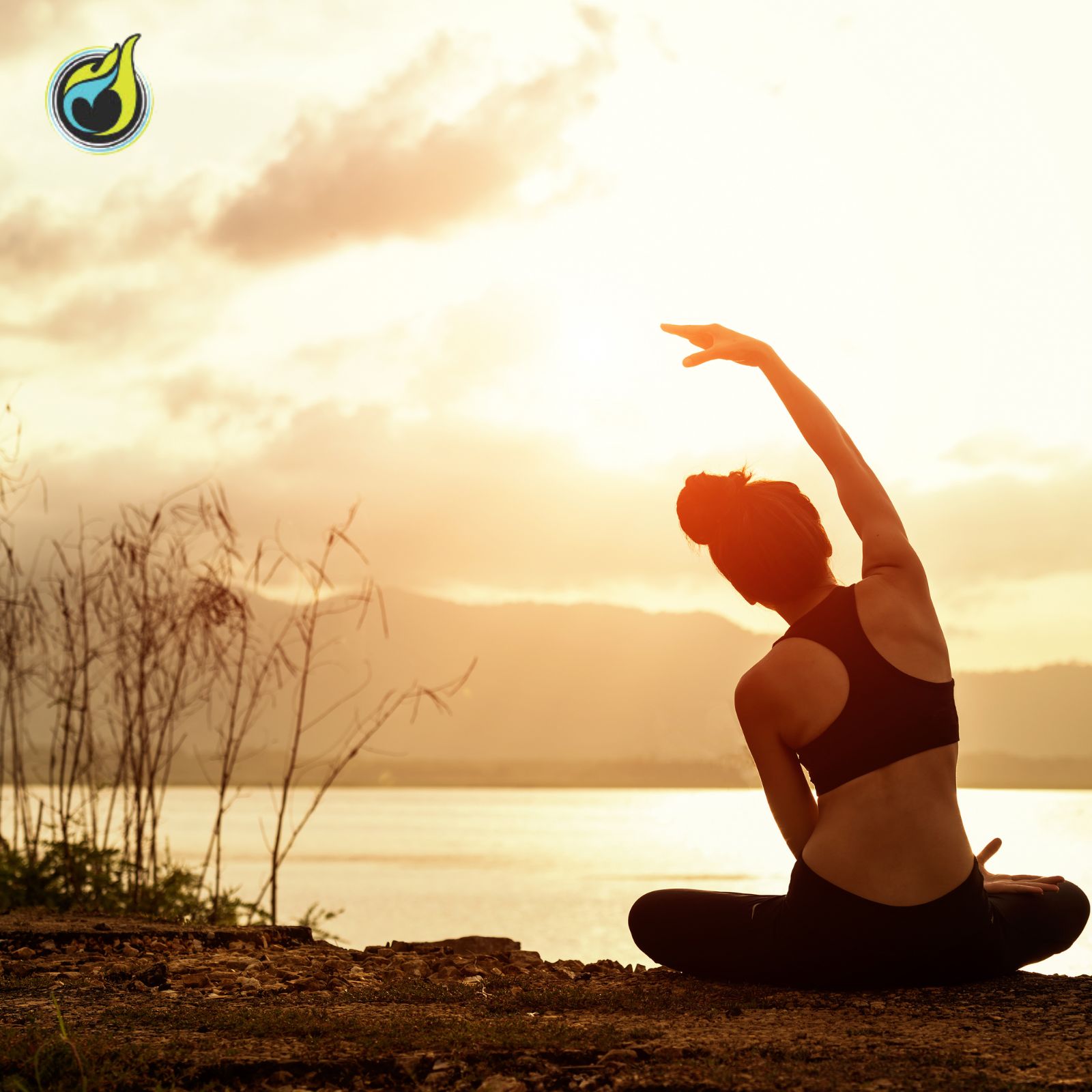 Person practicing yoga by the water at sunset.